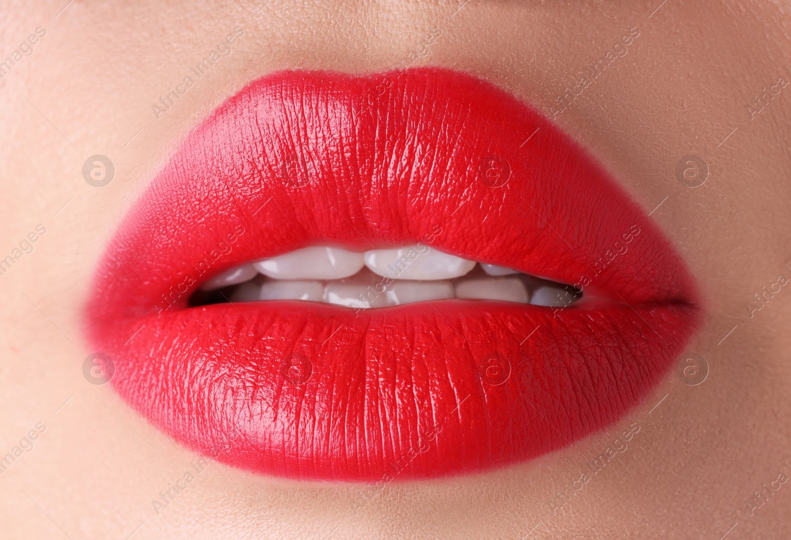 Photo of Woman with beautiful red lipstick on her lips, macro view
