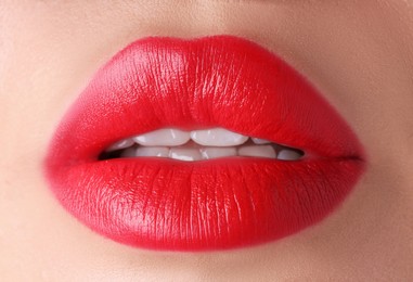 Photo of Woman with beautiful red lipstick on her lips, macro view