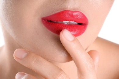 Photo of Woman with beautiful red lipstick on her lips against white background, closeup
