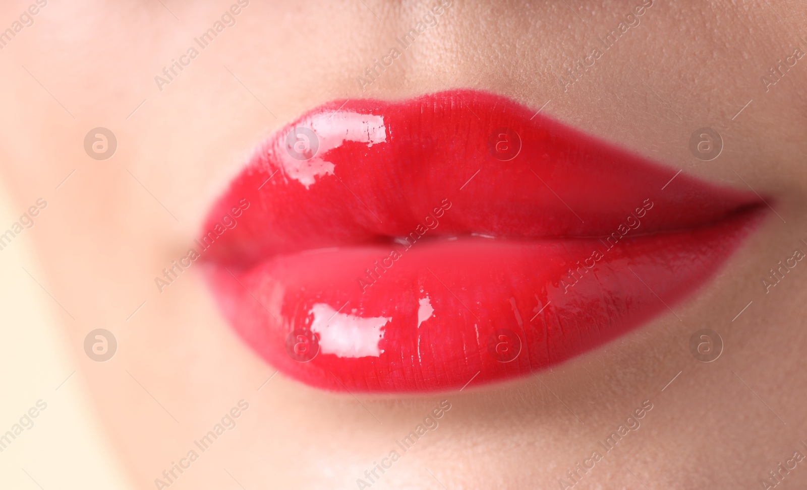 Photo of Woman with beautiful red lipstick on her lips, macro view