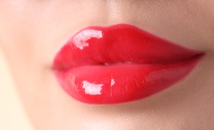 Photo of Woman with beautiful red lipstick on her lips, macro view