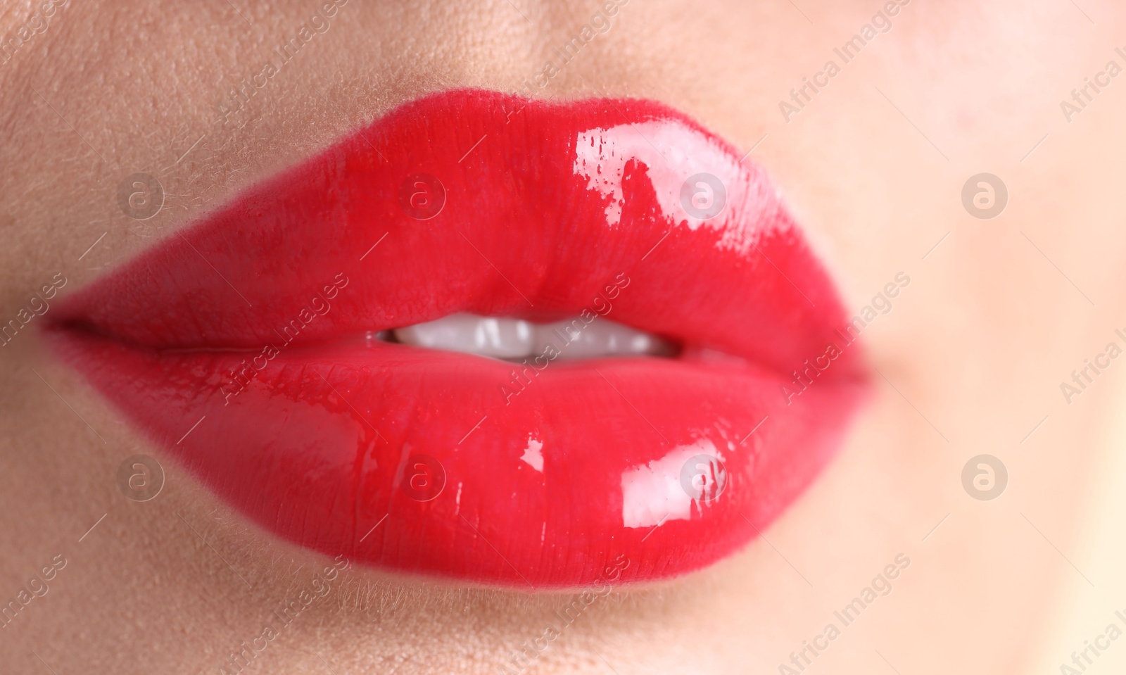Photo of Woman with beautiful red lipstick on her lips, macro view