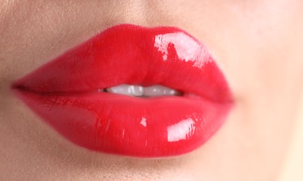 Photo of Woman with beautiful red lipstick on her lips, macro view