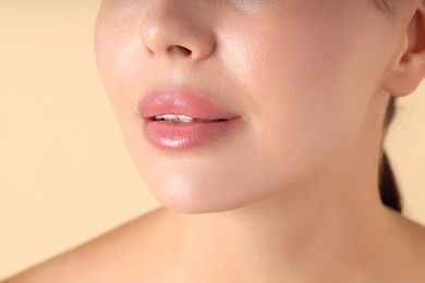 Photo of Woman with beautiful lips on beige background, macro view