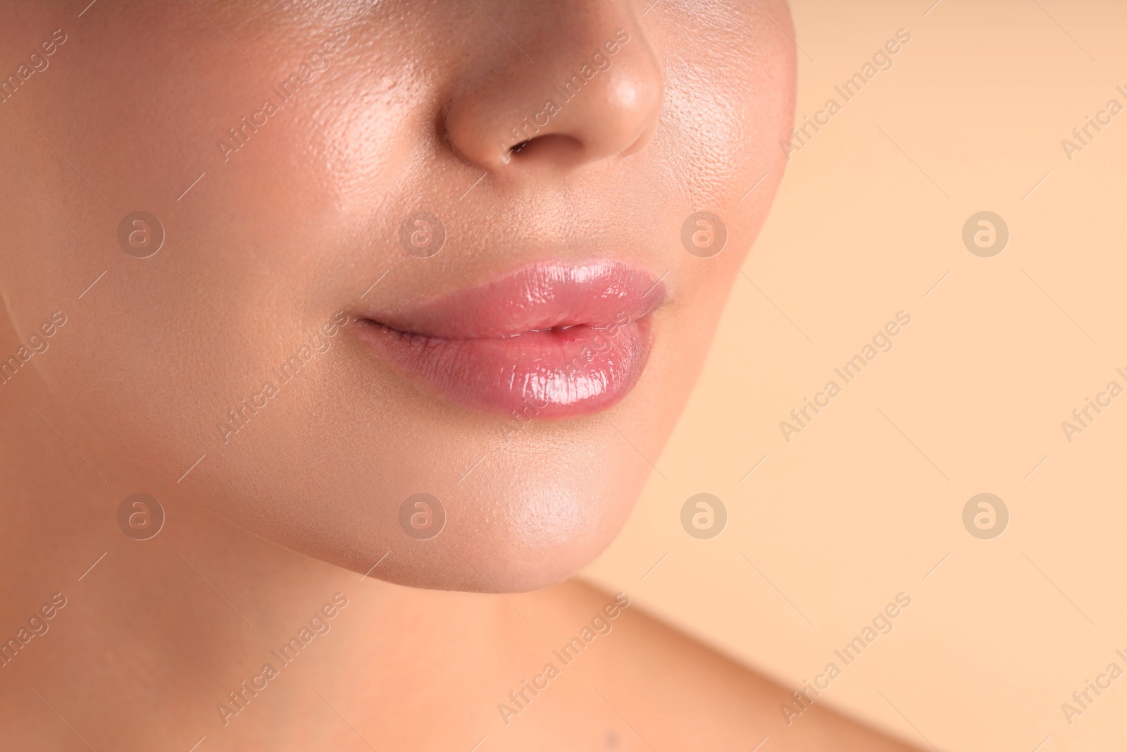 Photo of Woman with beautiful lips on beige background, macro view