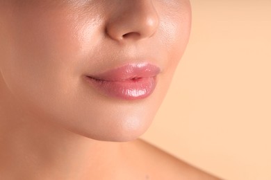 Photo of Woman with beautiful lips on beige background, macro view