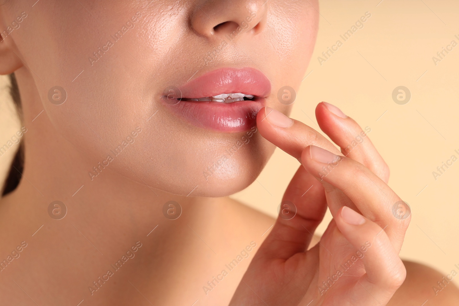 Photo of Woman with beautiful lips on beige background, macro view