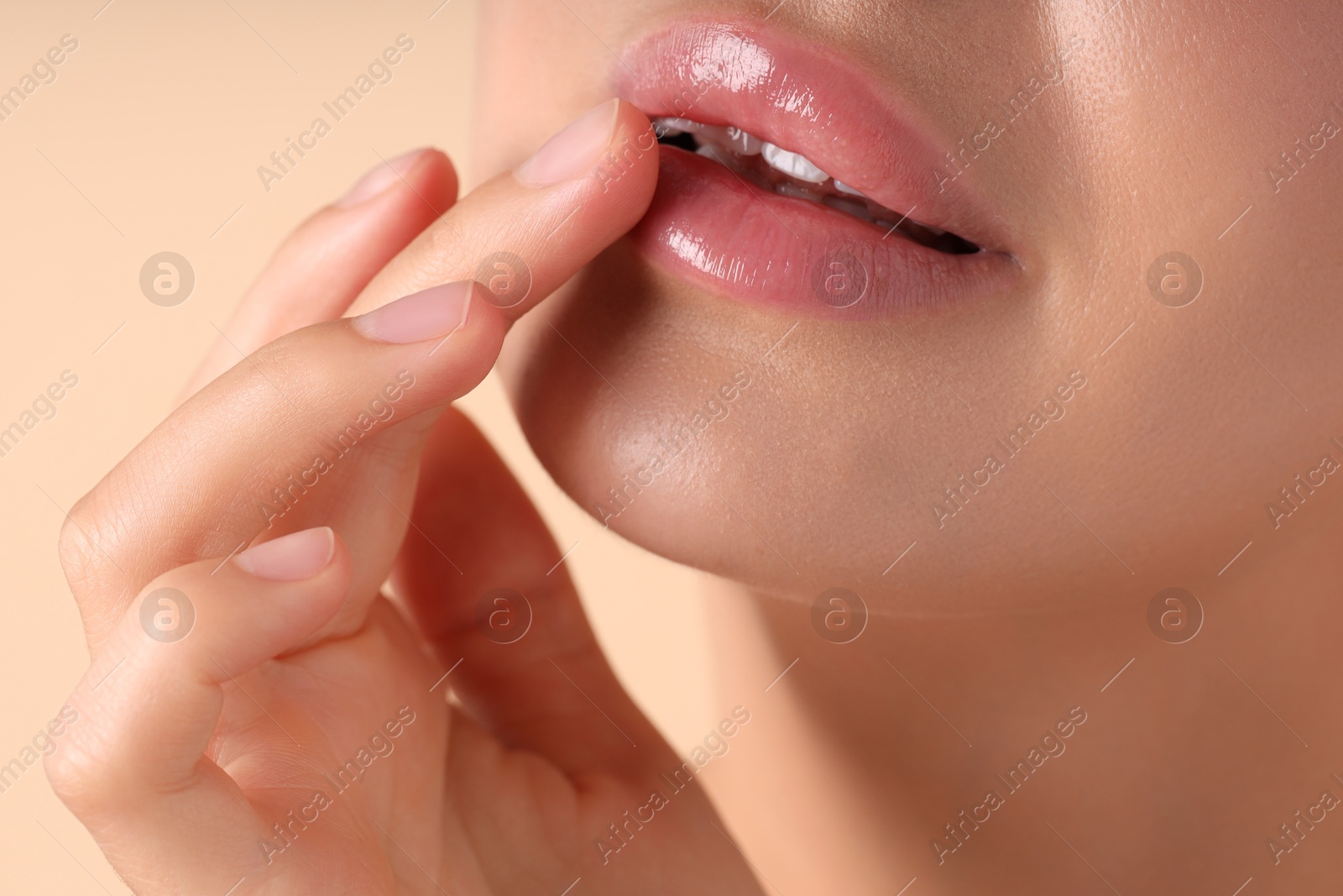 Photo of Woman with beautiful lips on beige background, macro view