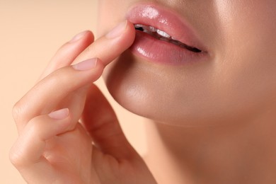 Photo of Woman with beautiful lips on beige background, macro view