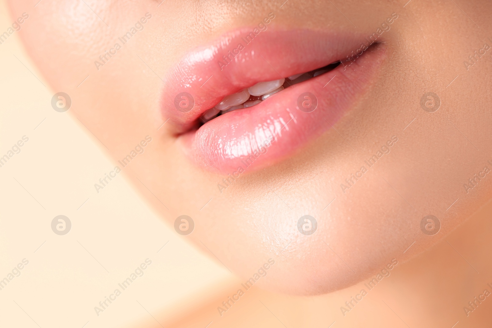 Photo of Woman with beautiful lips on beige background, macro view