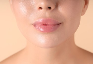 Photo of Woman with beautiful lips on beige background, macro view