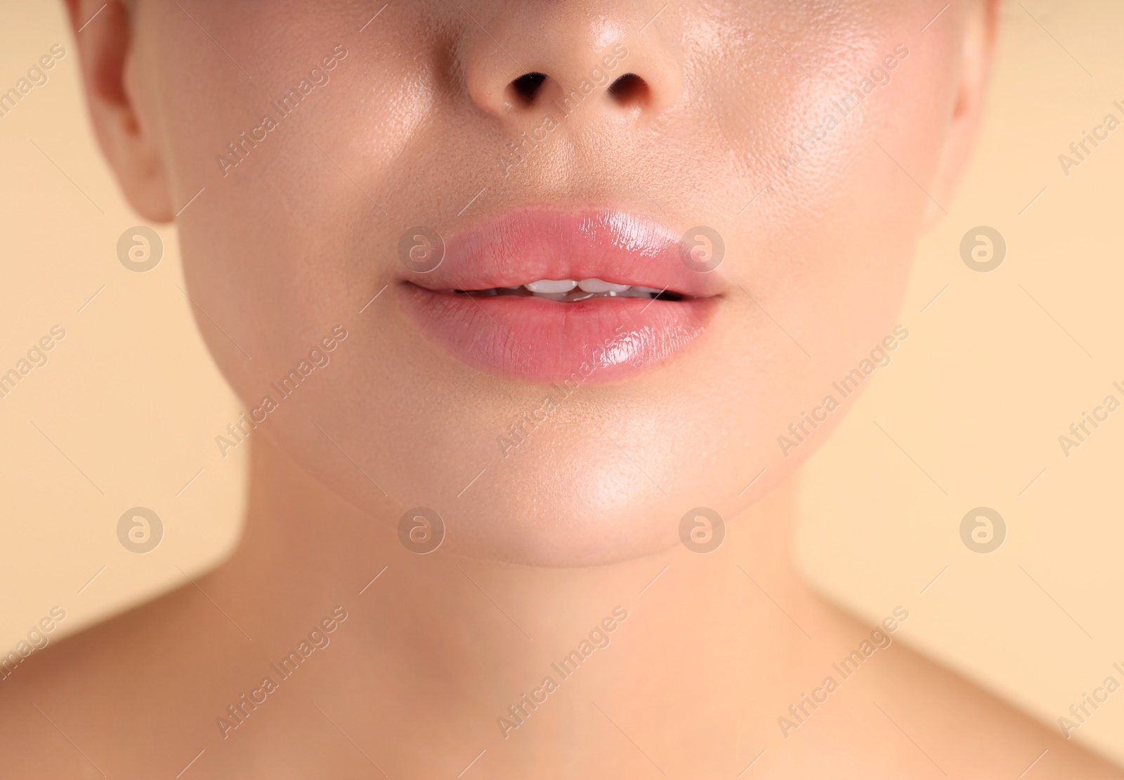 Photo of Woman with beautiful lips on beige background, macro view