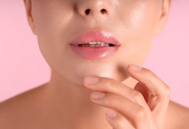 Photo of Woman with beautiful lips on pink background, macro view