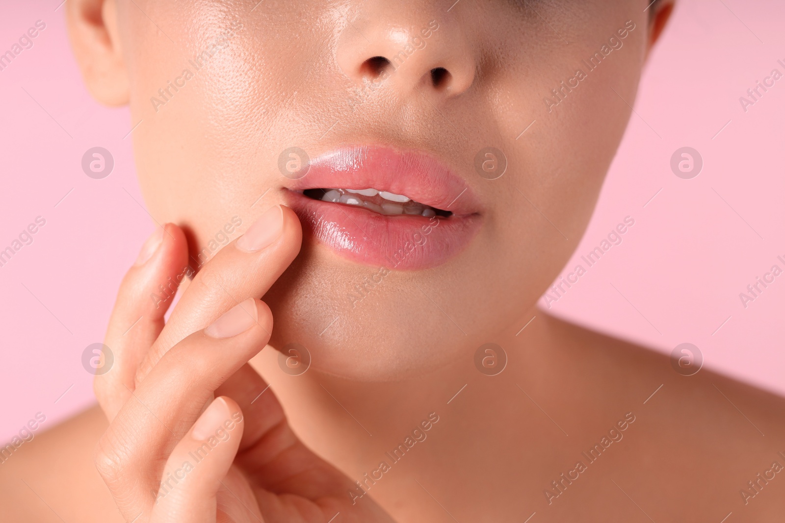 Photo of Woman with beautiful lips on pink background, macro view
