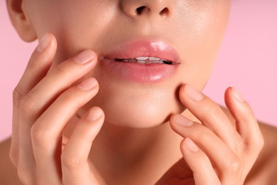 Photo of Woman with beautiful lips on pink background, macro view