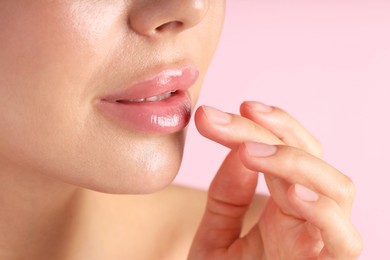 Photo of Woman with beautiful lips on pink background, macro view