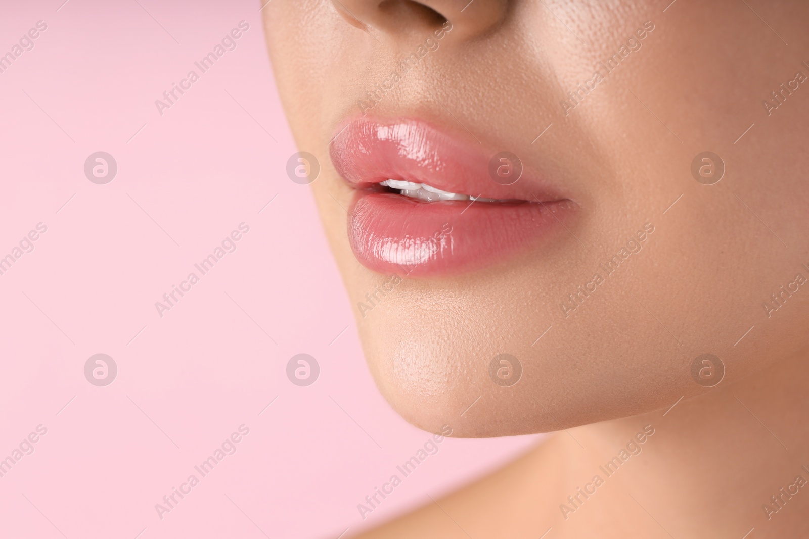 Photo of Woman with beautiful lips on pink background, macro view. Space for text