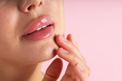 Photo of Woman with beautiful lips on pink background, macro view. Space for text
