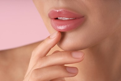 Photo of Woman with beautiful lips on pink background, macro view