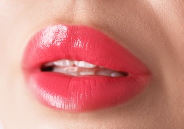 Photo of Woman with beautiful lipstick on her lips, macro view
