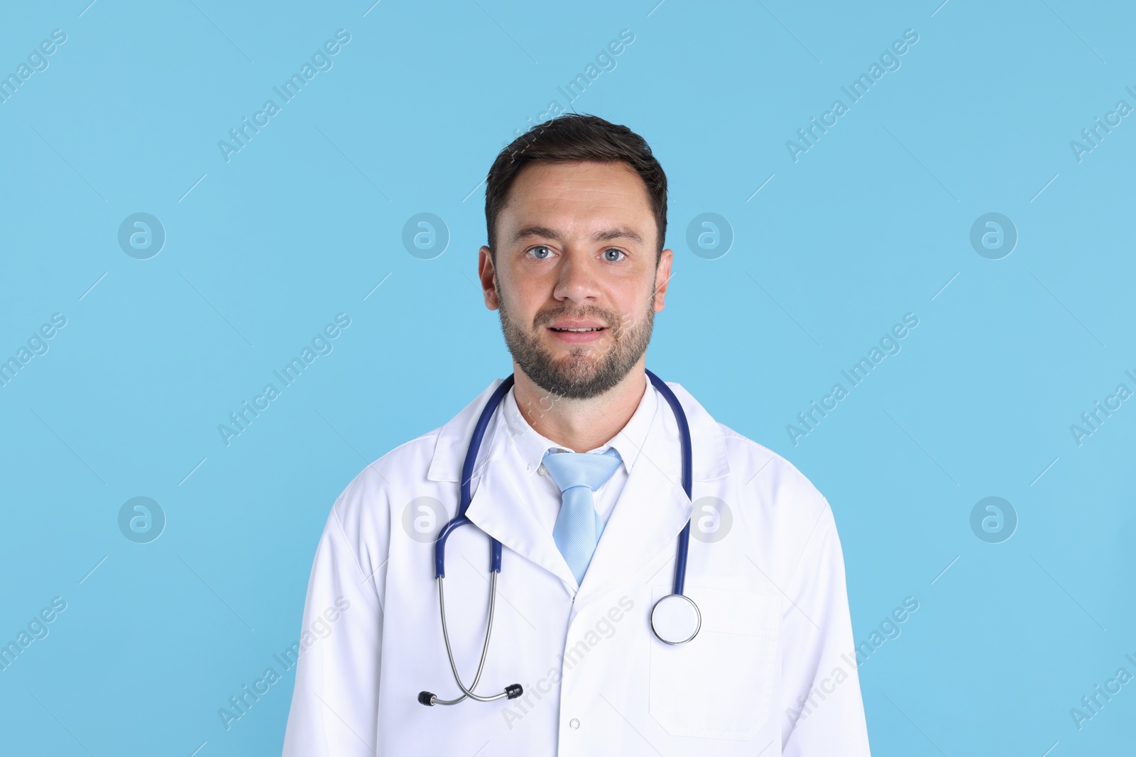 Photo of Pediatrician with stethoscope on light blue background