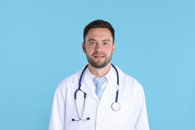 Photo of Pediatrician with stethoscope on light blue background