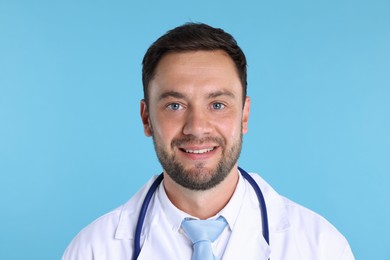 Photo of Pediatrician with stethoscope on light blue background