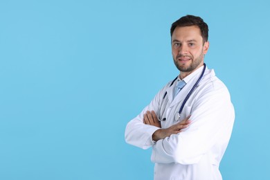 Photo of Pediatrician with stethoscope on light blue background. Space for text