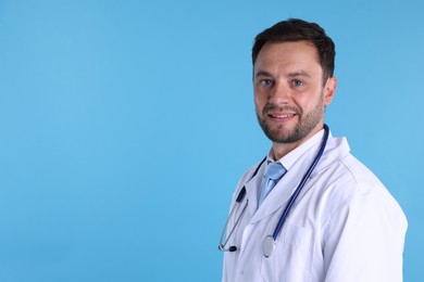 Photo of Pediatrician with stethoscope on light blue background. Space for text