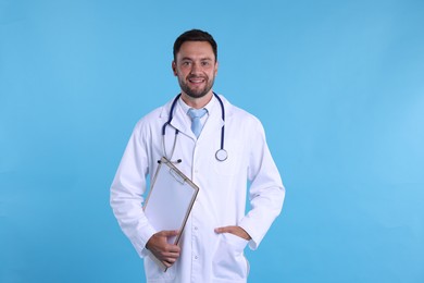 Photo of Pediatrician with stethoscope and clipboard on light blue background