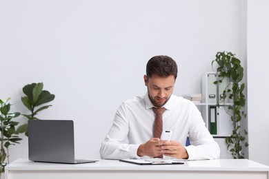 Photo of Man using remote to control air conditioner in office