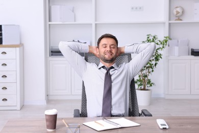 Photo of Man sitting at workplace in office with air conditioning