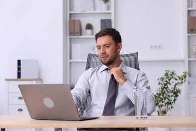 Photo of Air conditioning. Man suffering from heat at workplace in office