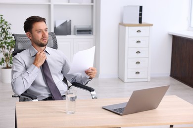 Photo of Air conditioning. Man suffering from heat at workplace in office