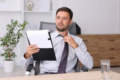 Photo of Air conditioning. Man suffering from heat at workplace in office