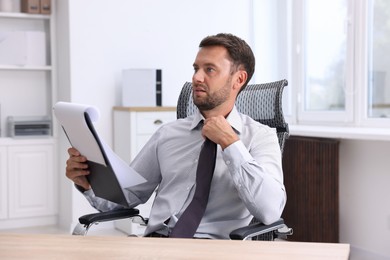 Photo of Air conditioning. Man suffering from heat at workplace in office