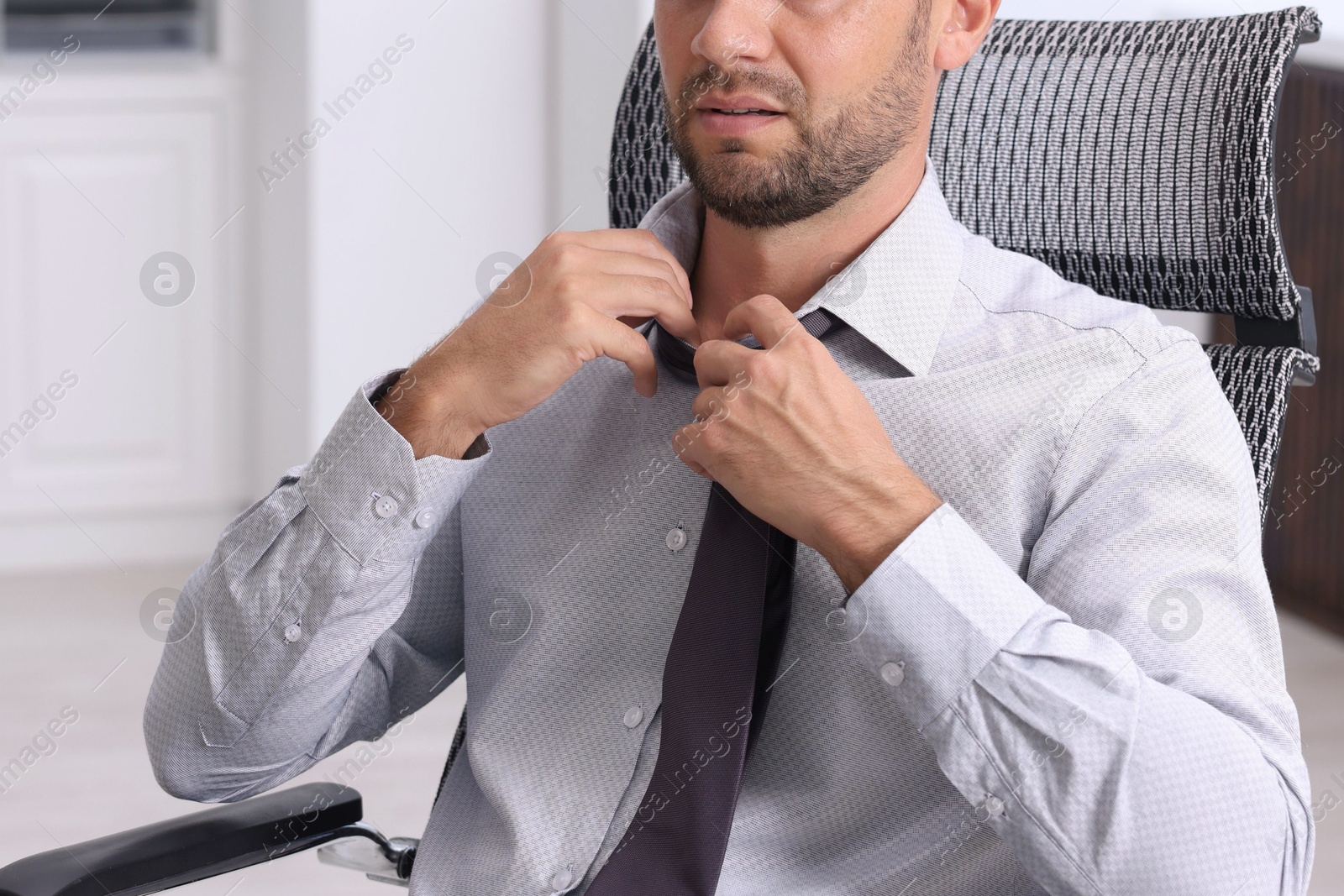 Photo of Air conditioning. Man suffering from heat at workplace in office, closeup