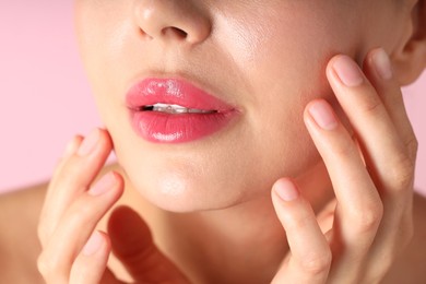 Photo of Woman with beautiful lipstick on her lips against pink background, macro view
