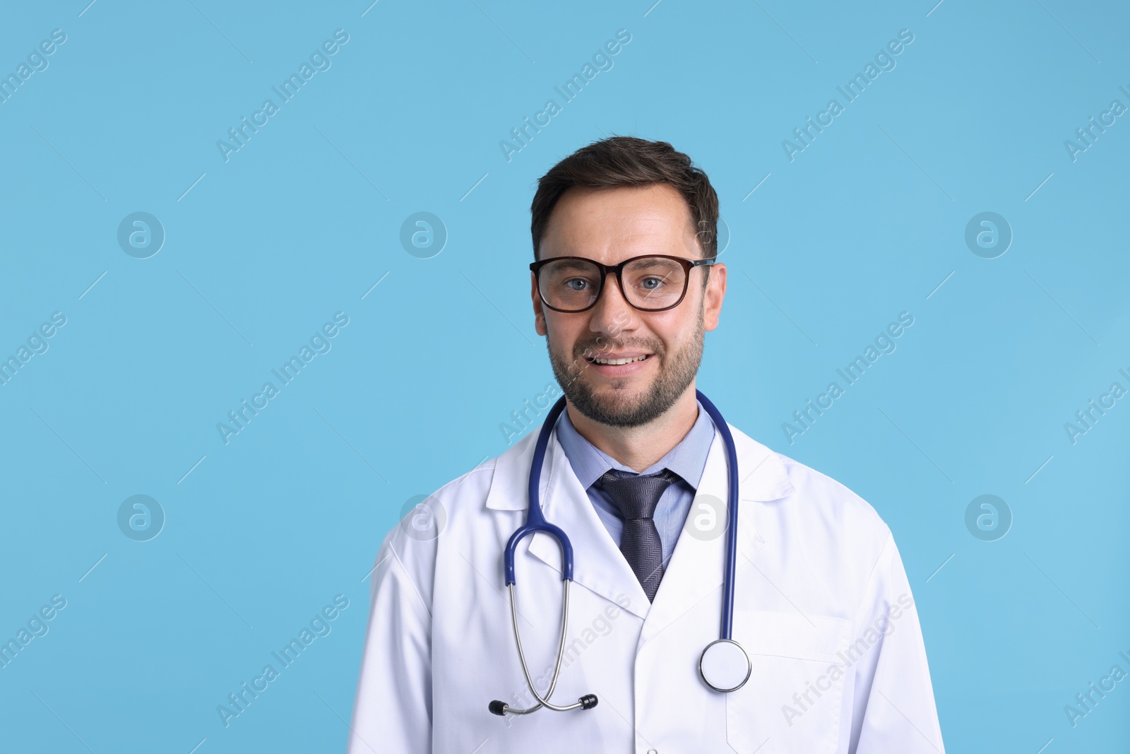 Photo of Pediatrician with stethoscope on light blue background