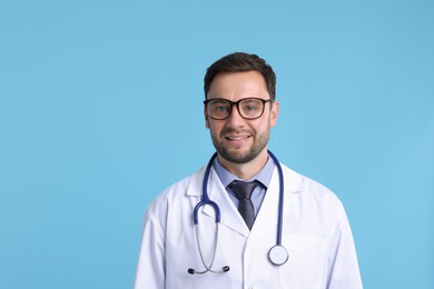 Photo of Pediatrician with stethoscope on light blue background