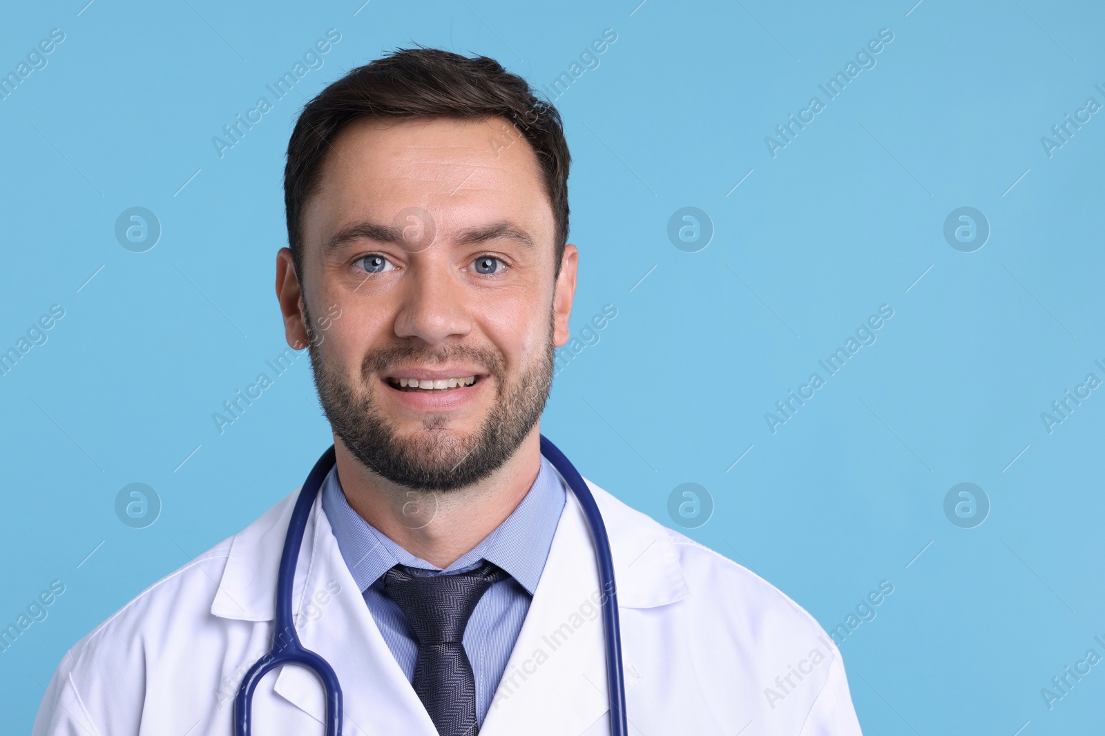 Photo of Pediatrician with stethoscope on light blue background. Space for text