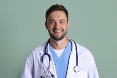 Photo of Portrait of pediatrician with stethoscope on green background