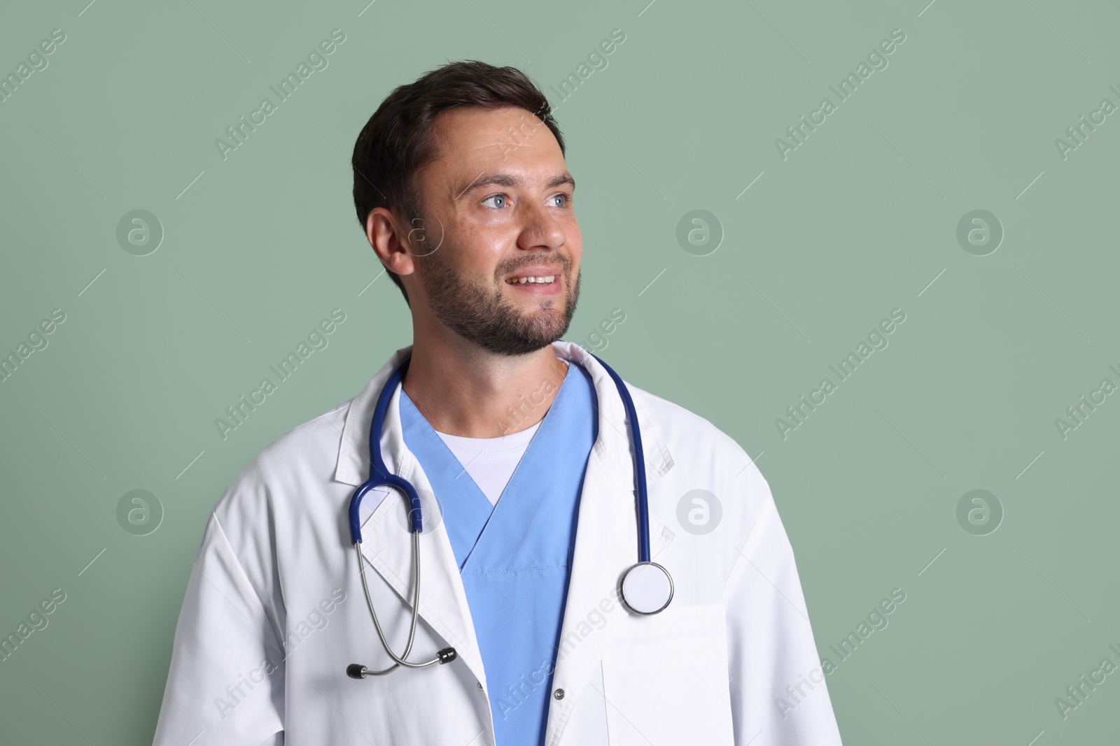 Photo of Portrait of pediatrician with stethoscope on green background