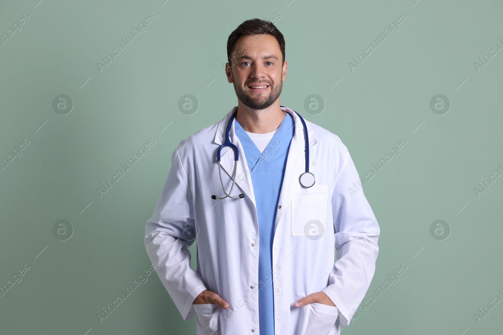 Photo of Portrait of pediatrician with stethoscope on green background