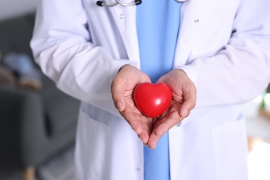 Photo of Pediatrician with heart model in hospital, closeup