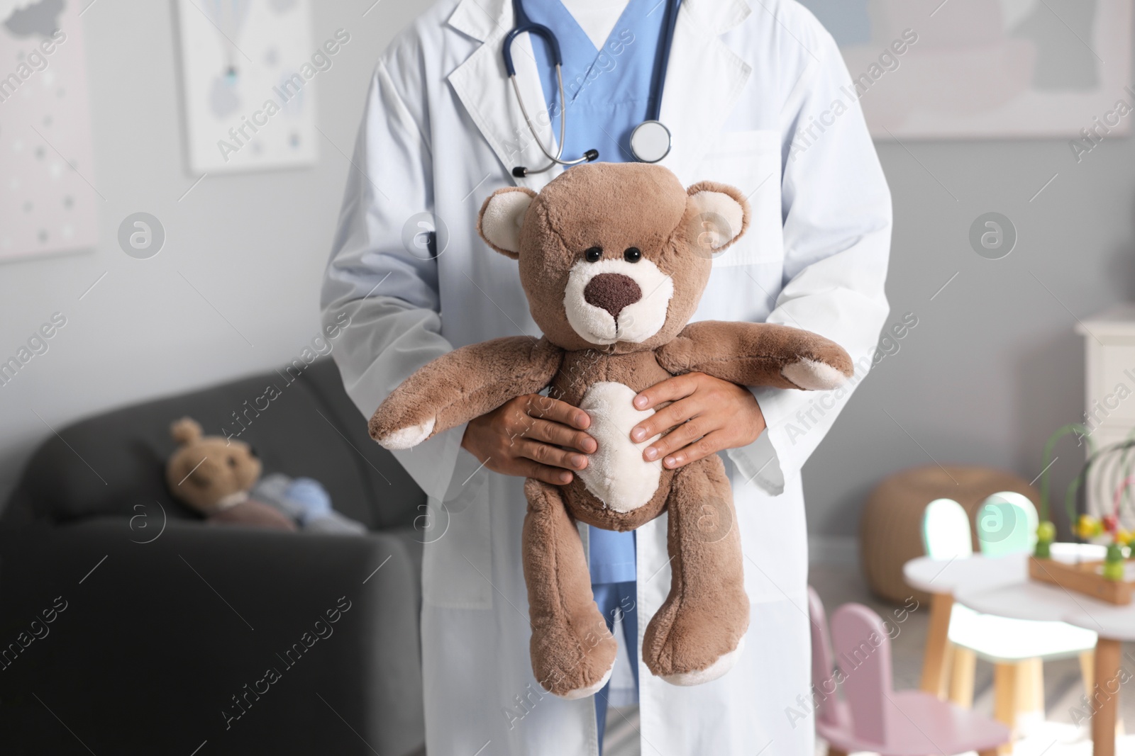 Photo of Pediatrician with teddy bear in hospital, closeup