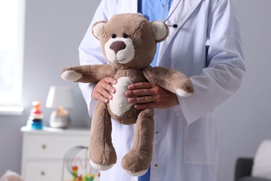 Photo of Pediatrician with teddy bear in hospital, closeup
