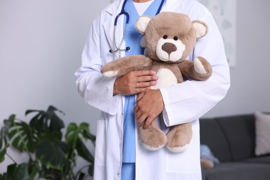 Photo of Pediatrician with teddy bear in hospital, closeup