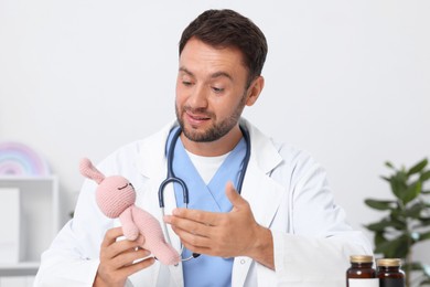 Photo of Pediatrician having video call with patient, view from camera