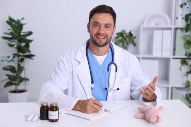 Photo of Pediatrician having video call with patient, view from camera